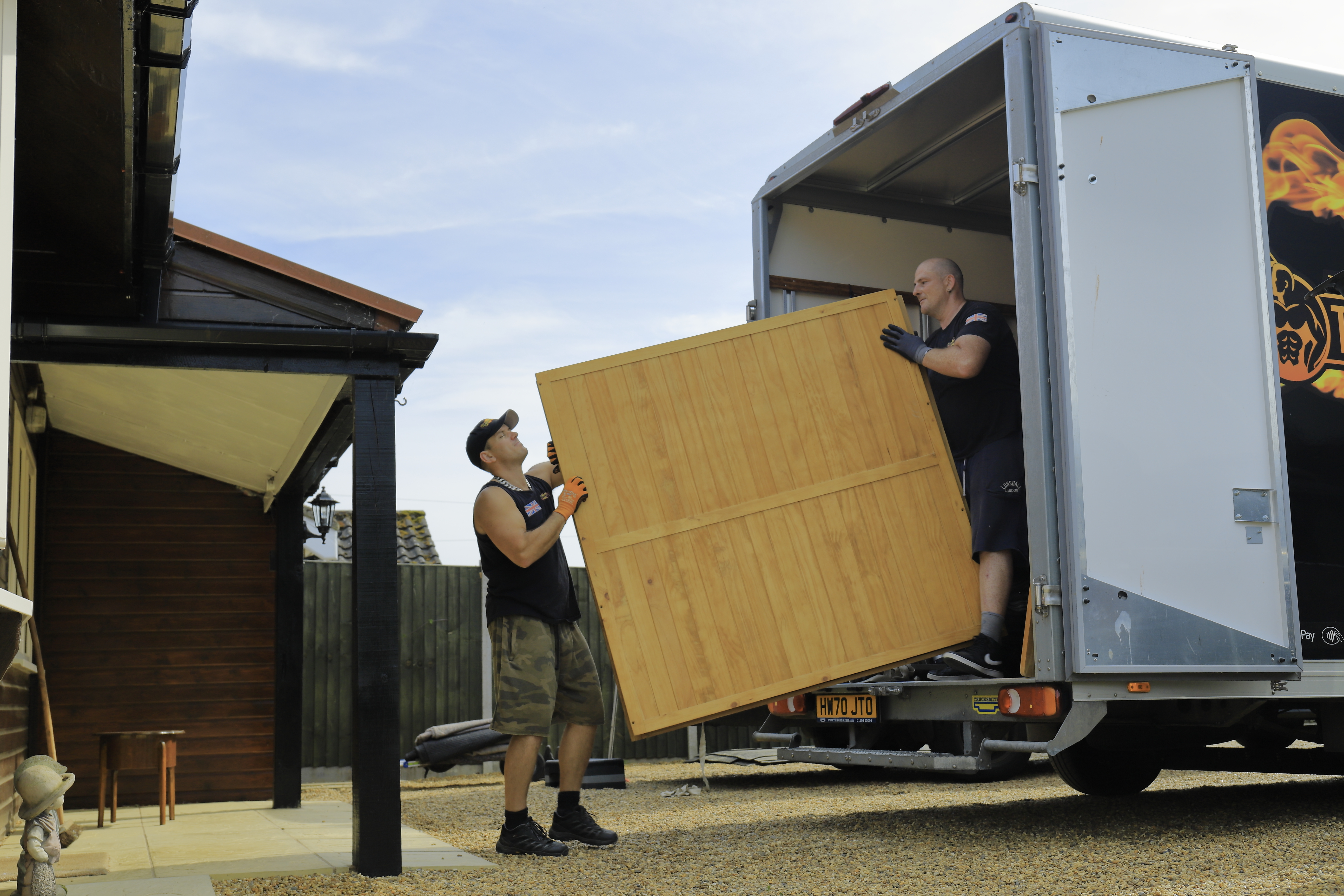 Team carefully carrying a large wardrobe